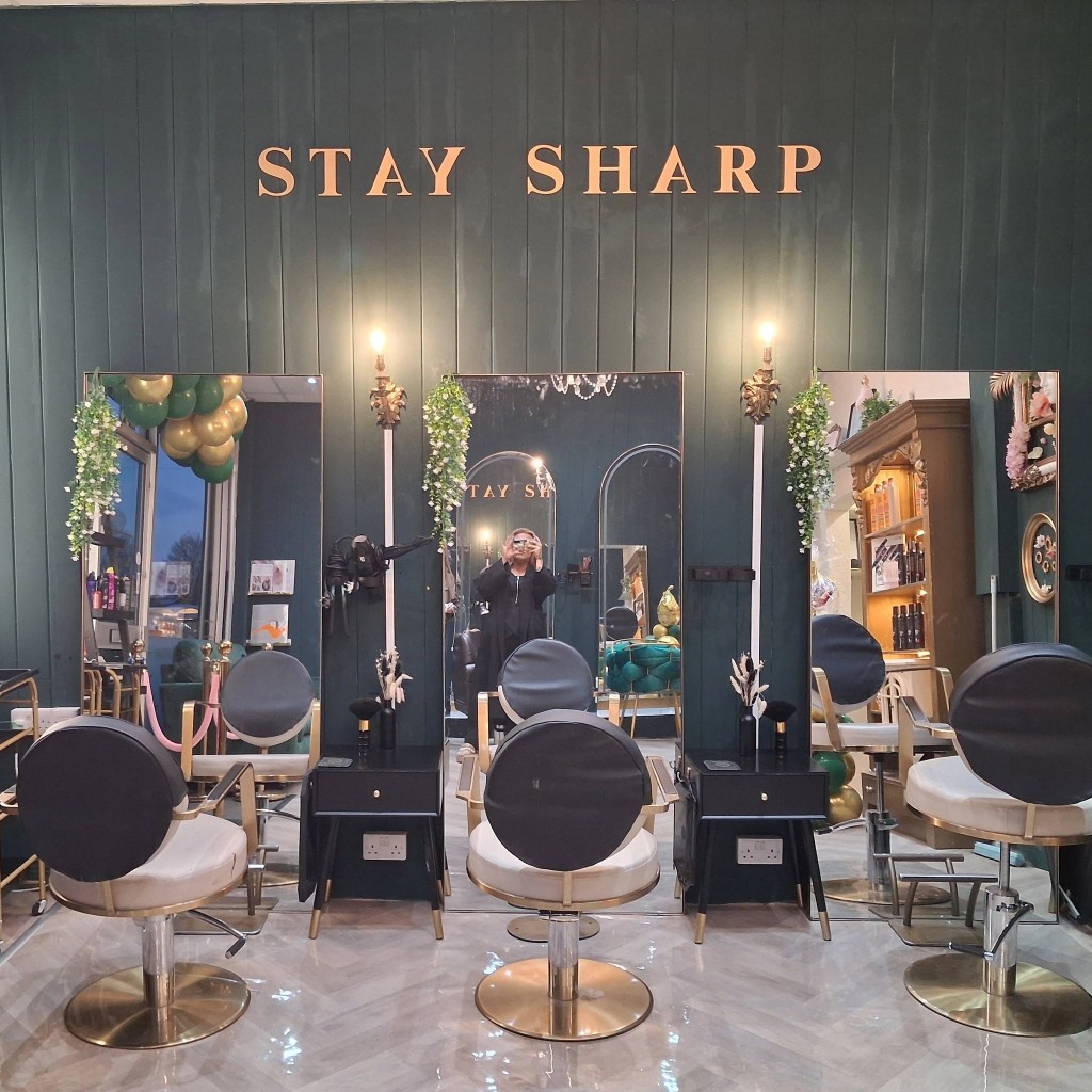 Stay Sharp styling stations — green walls and gold lettering